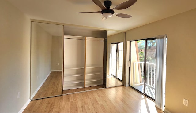 unfurnished bedroom with access to exterior, ceiling fan, baseboards, and wood finished floors