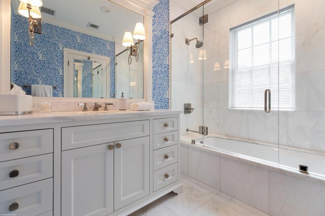 bathroom featuring tiled shower / bath combo, visible vents, ornamental molding, and vanity