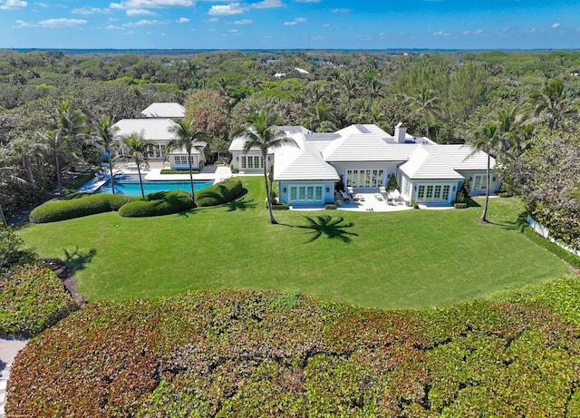 birds eye view of property with a forest view