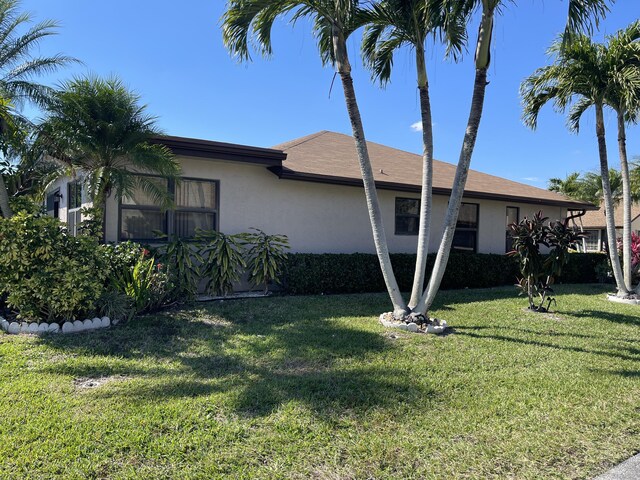 6302 Tall Cypress Cir, Greenacres, FL 33463 - view of front of property featuring stucco siding and a front yard