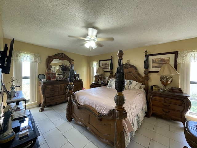 6302 Tall Cypress Cir, Greenacres, FL 33463 - bedroom with multiple windows, light tile patterned floors, a textured ceiling, and a ceiling fan