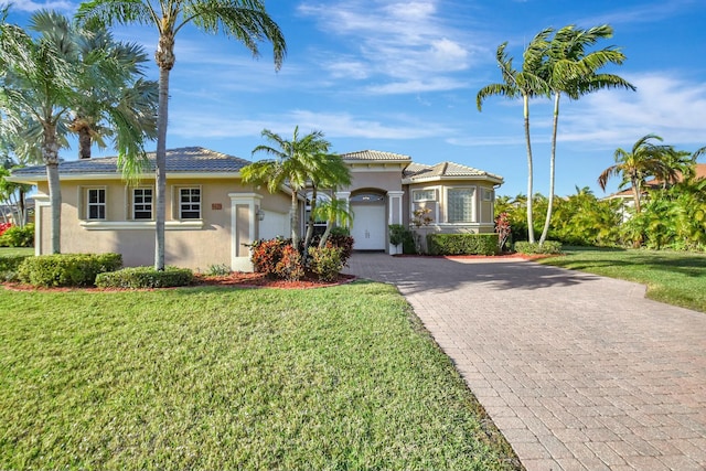 9429 Lantern Bay Cir, West Palm Beach, FL 33411 - view of front of home with decorative driveway, stucco siding, and a front lawn