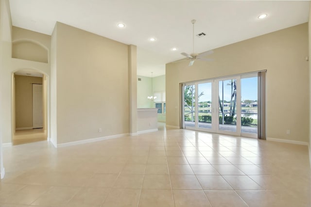 9429 Lantern Bay Cir, West Palm Beach, FL 33411 - unfurnished room with ceiling fan, arched walkways, recessed lighting, baseboards, and light tile patterned floors