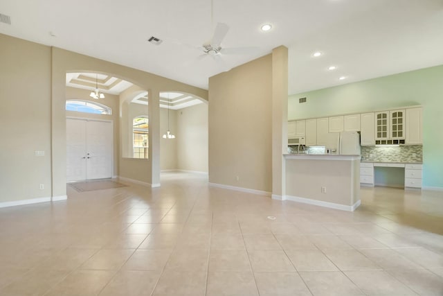 9429 Lantern Bay Cir, West Palm Beach, FL 33411 - unfurnished living room with arched walkways, light tile patterned floors, recessed lighting, a ceiling fan, and baseboards