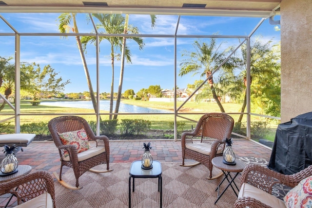 sunroom featuring a water view and a healthy amount of sunlight