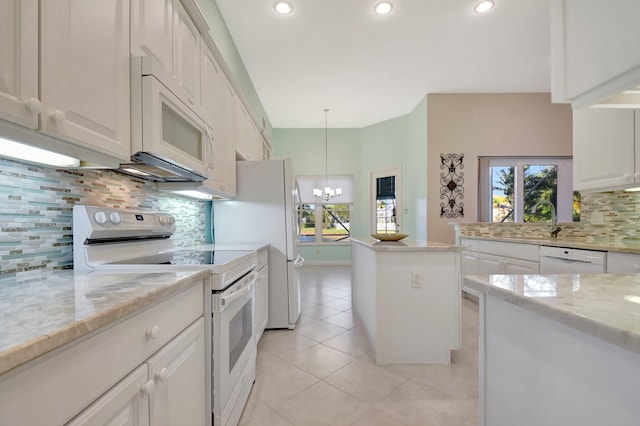9429 Lantern Bay Cir, West Palm Beach, FL 33411 - kitchen featuring white appliances, a chandelier, backsplash, light tile patterned floors, and white cabinetry