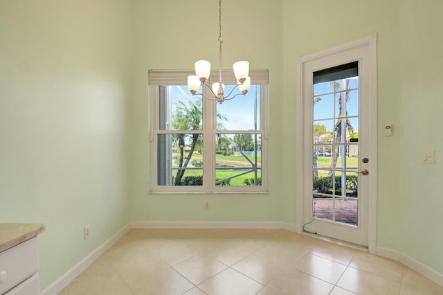 9429 Lantern Bay Cir, West Palm Beach, FL 33411 - unfurnished dining area featuring a chandelier, light tile patterned floors, and baseboards