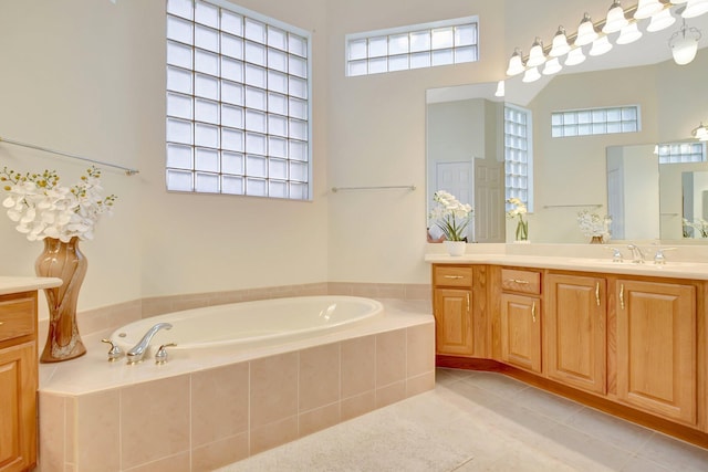 9429 Lantern Bay Cir, West Palm Beach, FL 33411 - bathroom with vanity, tile patterned flooring, a bath, healthy amount of natural light, and a towering ceiling