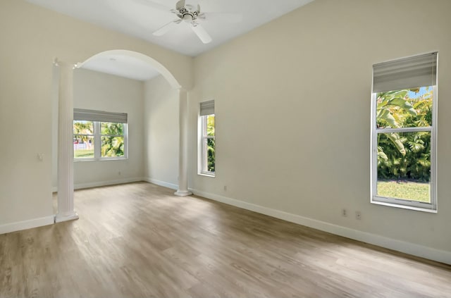 9429 Lantern Bay Cir, West Palm Beach, FL 33411 - empty room with arched walkways, wood finished floors, ceiling fan, and baseboards