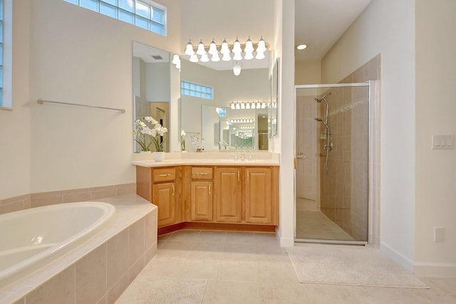 full bath with vanity, tile patterned flooring, a shower stall, and a bath