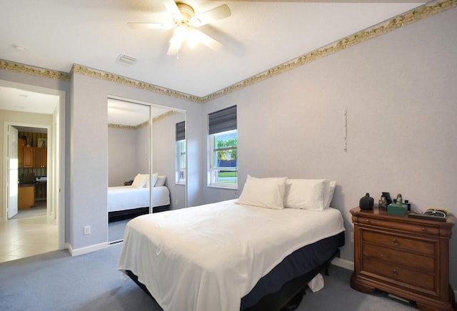 bedroom featuring baseboards, visible vents, ceiling fan, carpet floors, and a closet