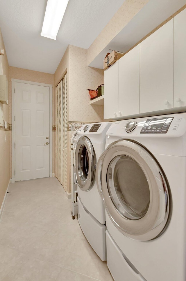 9429 Lantern Bay Cir, West Palm Beach, FL 33411 - laundry room with cabinet space, washing machine and clothes dryer, and baseboards