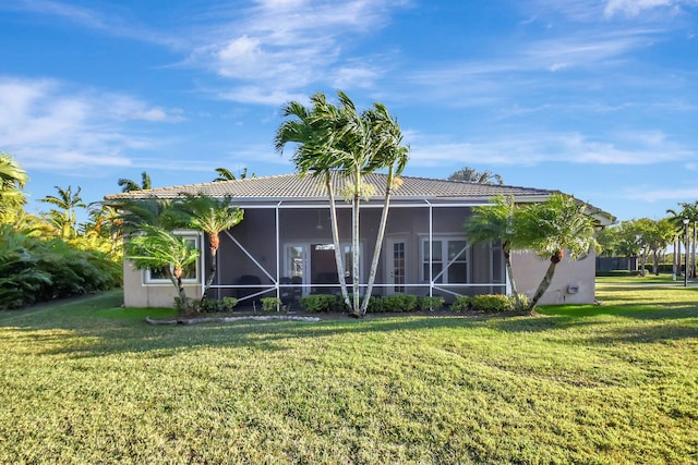 back of house featuring a lawn and stucco siding