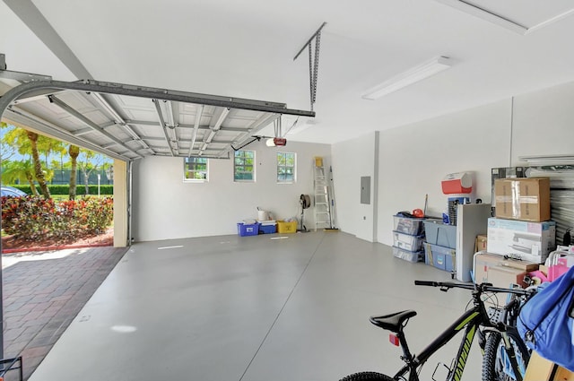 garage with a garage door opener and electric panel