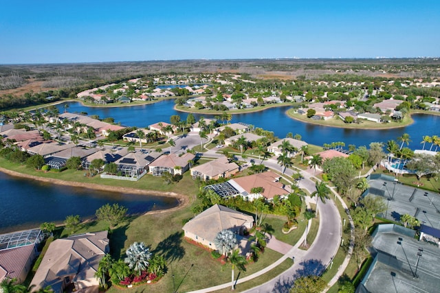 drone / aerial view featuring a water view and a residential view