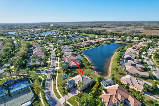 drone / aerial view featuring a water view and a residential view