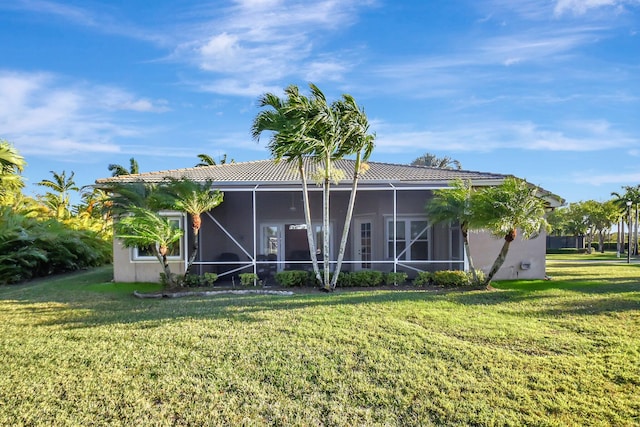 9429 Lantern Bay Cir, West Palm Beach, FL 33411 - back of house with a yard, stucco siding, a tile roof, and a sunroom