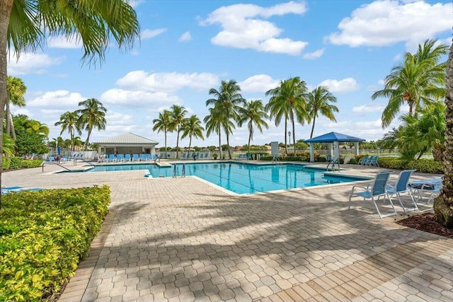 community pool with a gazebo and a patio area