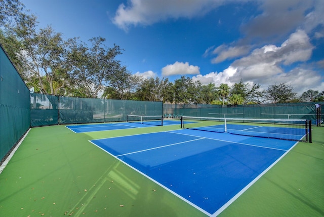 view of tennis court with fence