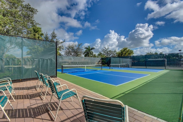 view of sport court featuring fence