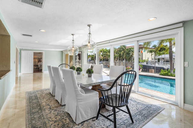 dining area featuring marble finish floor, visible vents, a textured ceiling, and baseboards