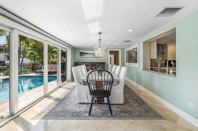 dining space featuring recessed lighting, visible vents, a textured ceiling, and baseboards