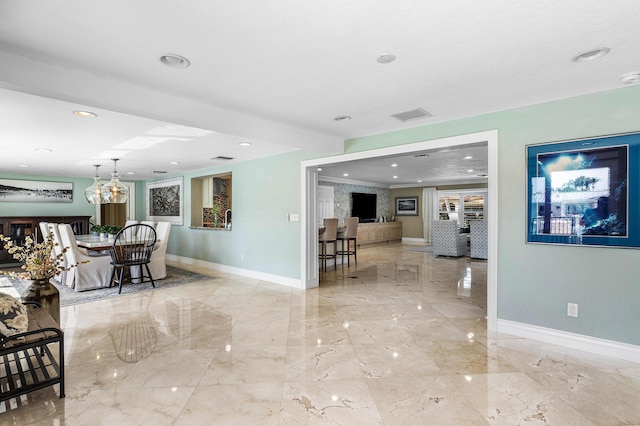 living room with recessed lighting, marble finish floor, visible vents, and baseboards