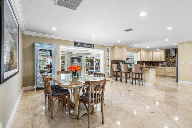 dining area featuring ornamental molding, marble finish floor, visible vents, and baseboards