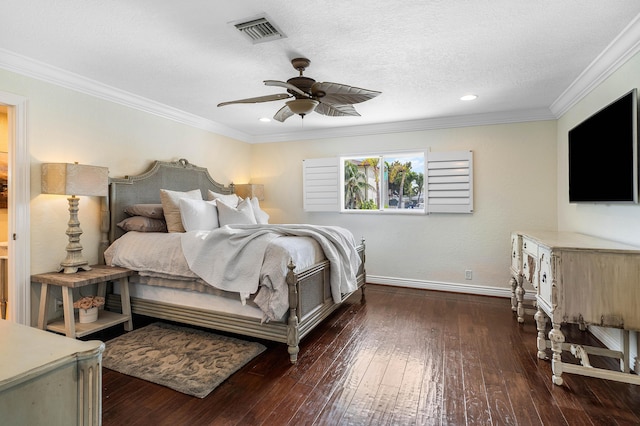 bedroom featuring crown molding, hardwood / wood-style flooring, visible vents, and baseboards