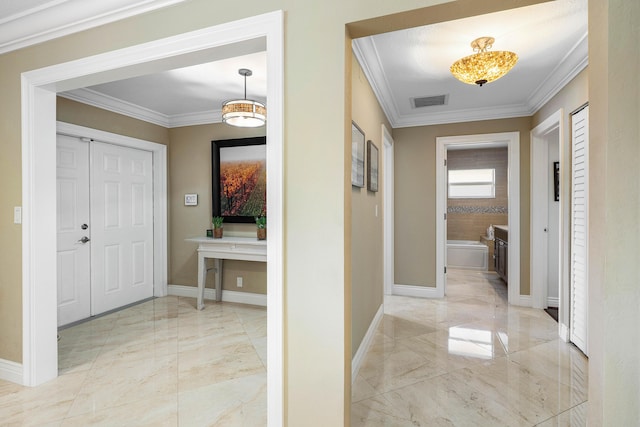 corridor featuring marble finish floor, ornamental molding, visible vents, and baseboards