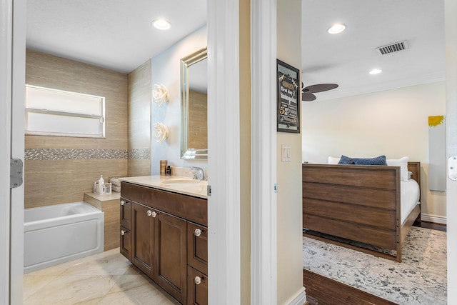 bathroom with recessed lighting, visible vents, ceiling fan, vanity, and a bath