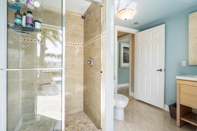 bathroom featuring marble finish floor, visible vents, toilet, a stall shower, and vanity