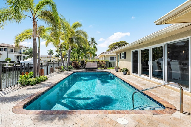 view of swimming pool featuring a fenced in pool, a patio area, and a fenced backyard