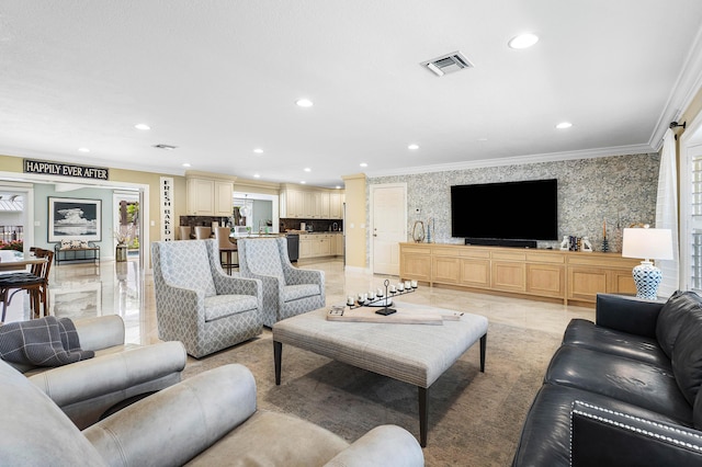 living area with wallpapered walls, visible vents, crown molding, and recessed lighting