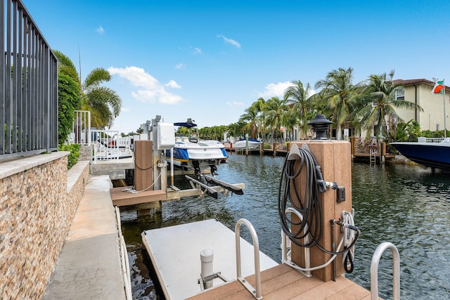 dock area with a water view and boat lift