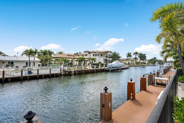 view of dock featuring a water view and a residential view