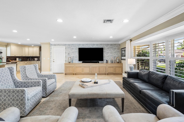 living area with wallpapered walls, visible vents, baseboards, ornamental molding, and recessed lighting