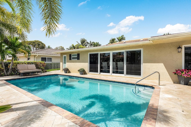 view of pool with a fenced in pool, a patio area, and fence