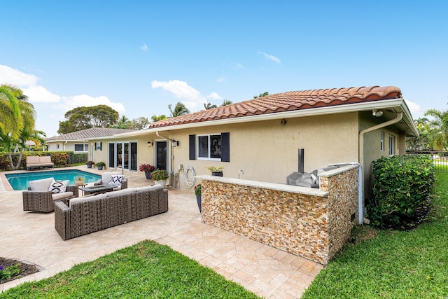 back of property featuring a patio area, a tile roof, fence, and stucco siding