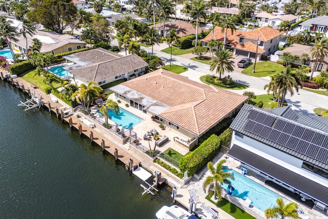 drone / aerial view featuring a water view and a residential view