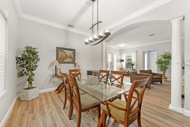 dining space with arched walkways, visible vents, light wood-type flooring, and decorative columns