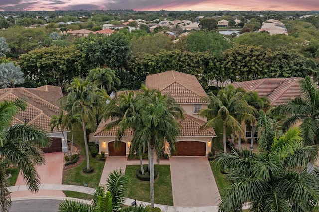 aerial view at dusk featuring a water view