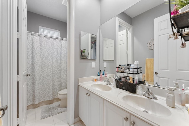 full bathroom featuring a sink, toilet, double vanity, and tile patterned floors