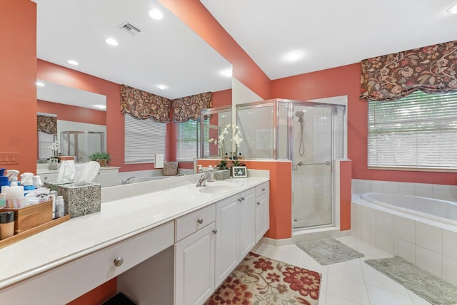 bathroom featuring visible vents, a stall shower, tile patterned flooring, a bath, and vanity