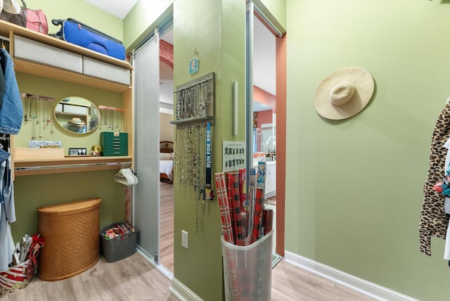 interior space with baseboards and wood finished floors