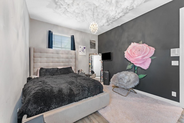 bedroom with an inviting chandelier and baseboards