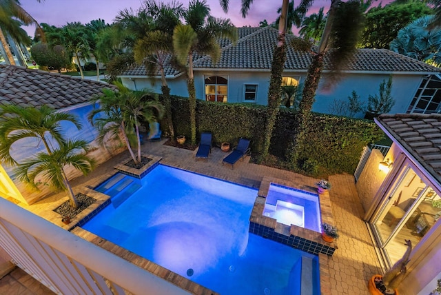 view of swimming pool with a pool with connected hot tub