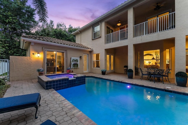 view of swimming pool featuring a patio and a pool with connected hot tub