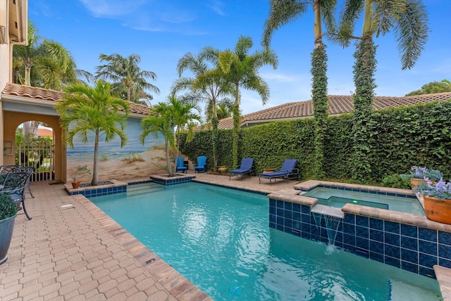 view of swimming pool with a patio area, a pool with connected hot tub, and a fenced backyard