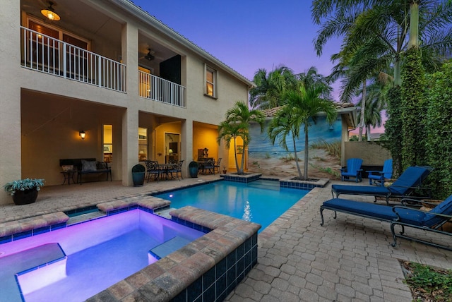 view of swimming pool with a pool with connected hot tub, ceiling fan, and a patio area